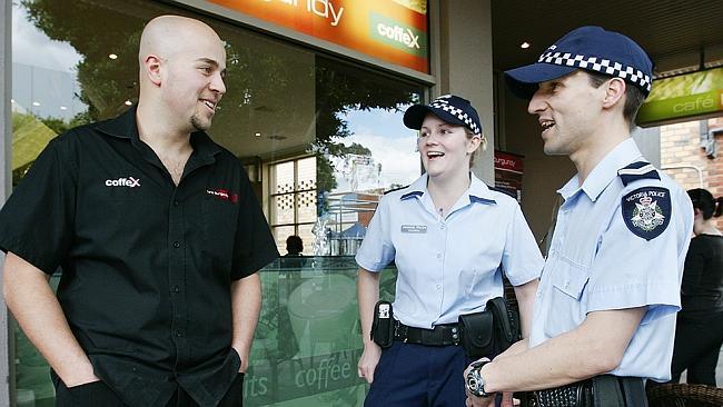 Constable Jessica Moran and Senior Constable Robbie Mascia chat to Hamad Sleiman, manager of Heidelberg's Cafe Burgundy. 