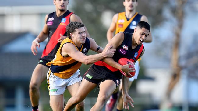 Dylan Exposto of Pascoe Vale is tackled. (Photo by Josh Chadwick)