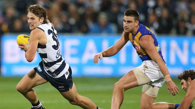 Geelong midfielder Tom Atkins burtsts away from Elliot Yeo. Picture: Michael Klein.