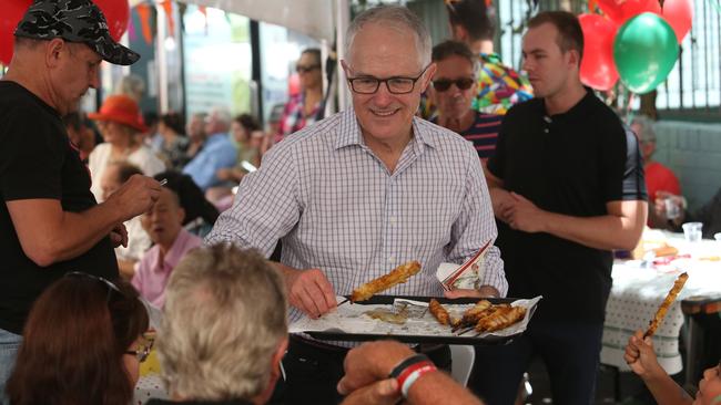 Prime Minister Malcolm Turnbull takes his turn serving up food at the Wayside Chapel on Christmas Day. Picture: James Croucher