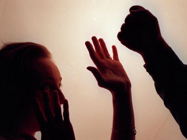 Domestic violence silhouette generic image - fist raised against woman./Violence