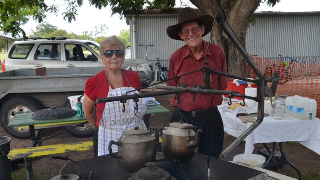 Betty and Bill Lucas cooking up some damper and boiling the billy tea for the students.