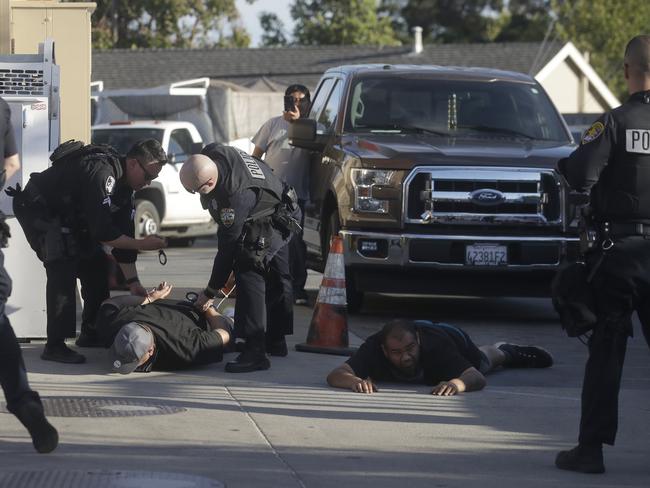 Police officers apprehend two men in Redwood City, California. Picture: AP