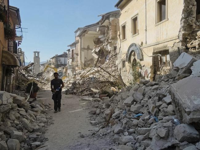 A man walks down a devastated street in Amatrice after the magnitude 6.2 earthquake struck. Picture: AP/Emilio Fraile