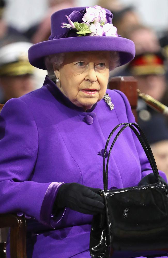 Queen Elizabeth II uses her handbag to convey signals to staff. Putting it on the table at dinner means she wants the event to end and putting it on the floor is a sign to her ladies in waiting to rescue her. Picture: AFP Photo/Pool/Chris Jackson