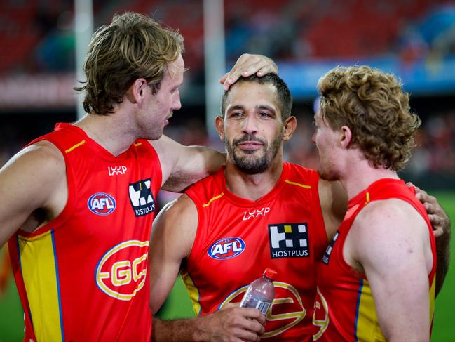 Jack Lukosius, Ben Long and Matt Rowell celebrate after their win over Essendon. Picture: Russell Freeman/AFL Photos via Getty Images.