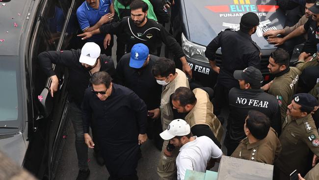 Imran Khan arrives to join an anti-government march towards capital Islamabad. Photo by Arif ALI / AFP