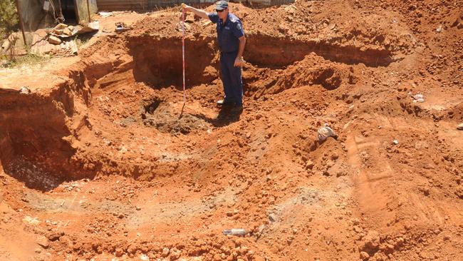 Police excavate the backyard of a Terowie house after the bones of pension Martin Meffert were found inside the home in October 2013.