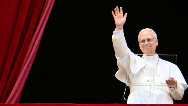 Pope Leo XIV waves to the crowd as he delivers the Regina Caeli prayer from the main central loggia of St Peter's basilica in The Vatican, on May 11, 2025. (Photo by Alberto PIZZOLI / AFP)