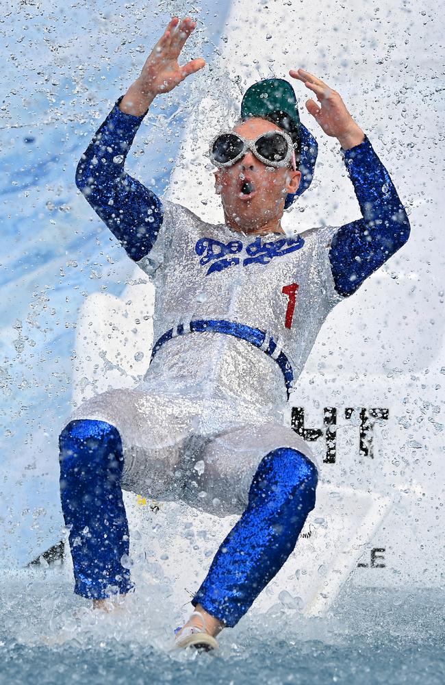 The umpire reacts as he hits the water. Picture: Quinn Rooney/Getty Images