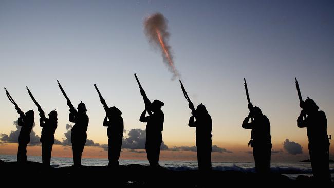 Members of the Albert Battery fire a volley during the dawn service at Currumbin Surf Life Saving Club.