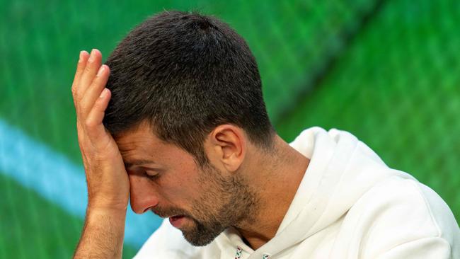 erbia's Novak Djokovic reacts as he speaks during a press conference in the Media Theatre at the Broadcast Centre following his defeat in the men's singles final tennis matchagainst Spain's Carlos Alcaraz on the last day of the 2023 Wimbledon Championships at The All England Tennis Club in Wimbledon, southwest London, on July 16, 2023. (Photo by Joe TOTH / various sources / AFP) / RESTRICTED TO EDITORIAL USE