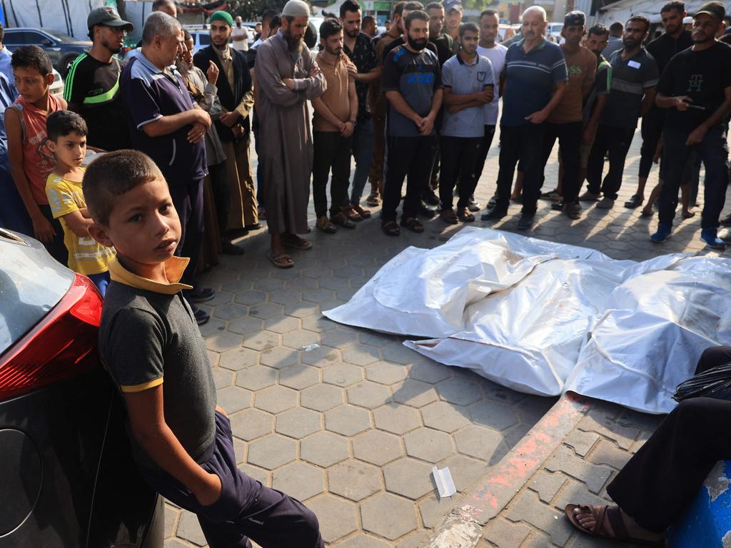 Palestinians pray over the bodies of victims of Israeli bombardment in the yard of the al-Aqsa Martyr's hospital in Deir el-Balah in the central Gaza Strip. Picture: AFP