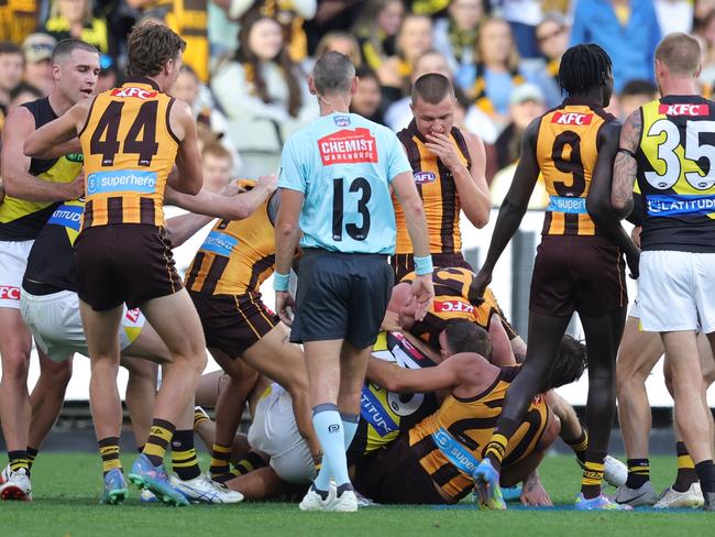 Tensions rise on the MCG as Hawks celebrate centenary