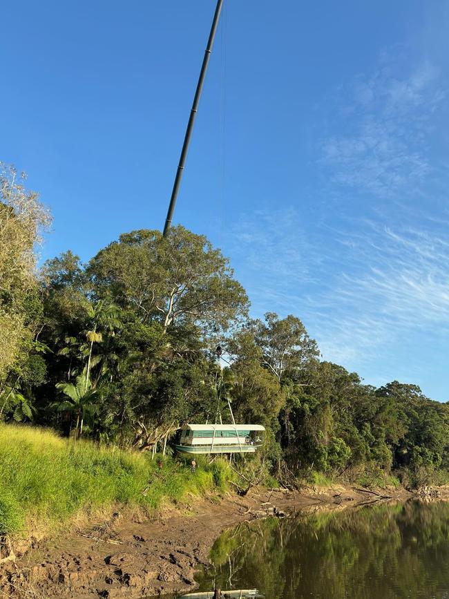 A CleanCo crane gets the Kuranda Riverboat back in the water last week after being high and dry for almost six months. Picture: Kuranda Riverboat