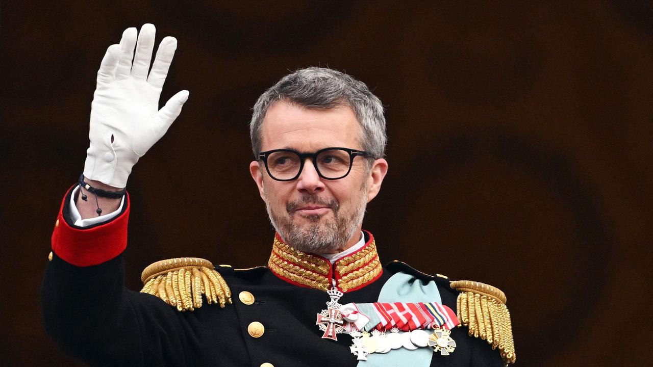 Danish King Frederik X waves to the crowd after a declaration of his accession to the throne by the Danish prime minister, on the balcony of Christiansborg Palace in Copenhagen, Denmark on January 14, 2024. Denmark turned a page in its history on January 14 as Queen Margrethe II abdicated the throne and her son became King Frederik X, with more than 100,000 Danes turning out for the unprecedented event. (Photo by Jonathan NACKSTRAND / AFP)