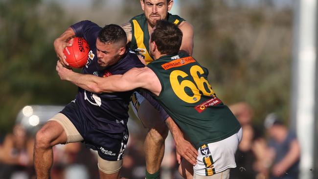 Seville’s Brent Pereira is tackled by Yarra Junction's Cameron Hoare. Picture: Stuart Milligan