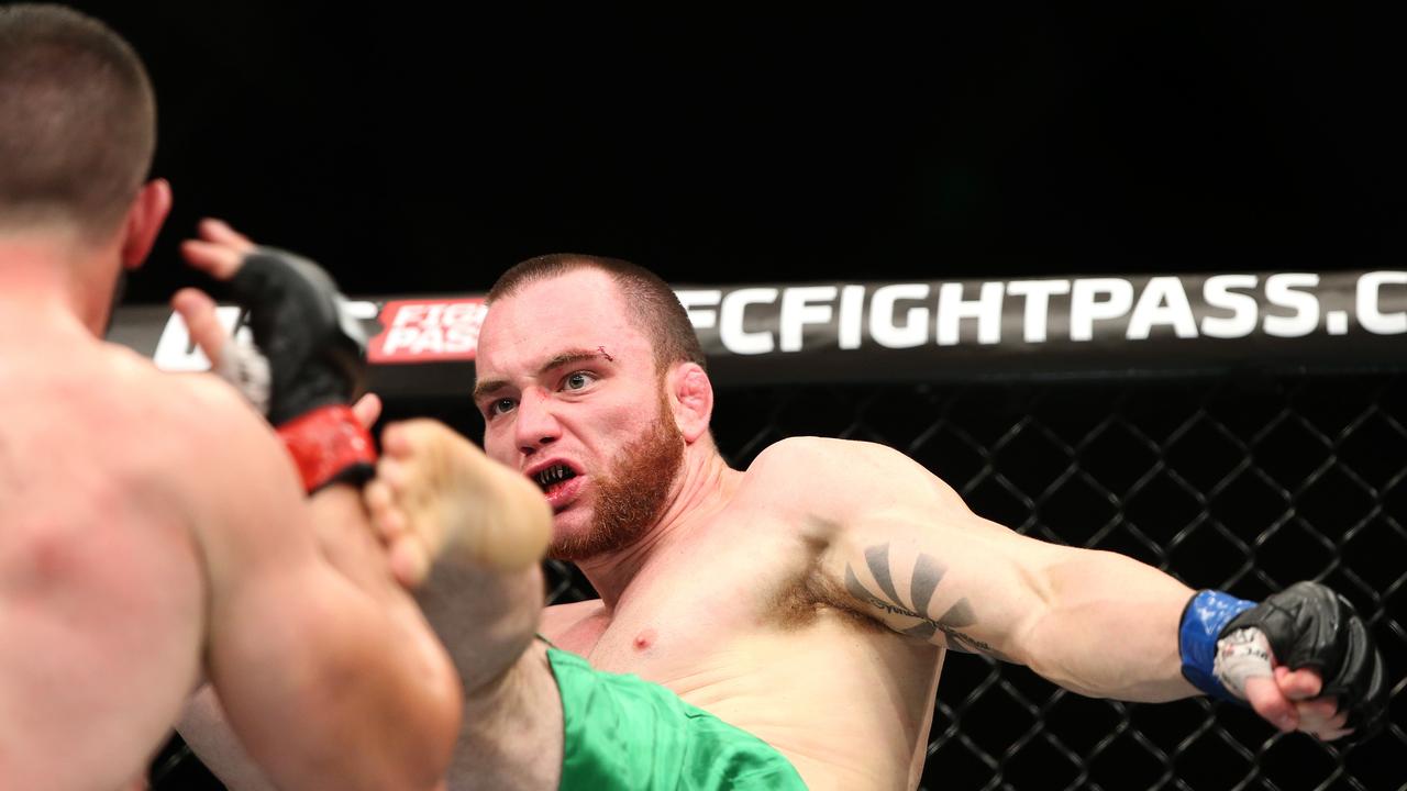 Sarah's pictures of the week - week 6 - UFC - Adelaide Entertainment Centre. Coaching from the sidelines in the Vik Grujic (dark hair) and Brendan O'Reilly (Reddish beard green shorts) Welterweight bout. Photo Sarah Reed.