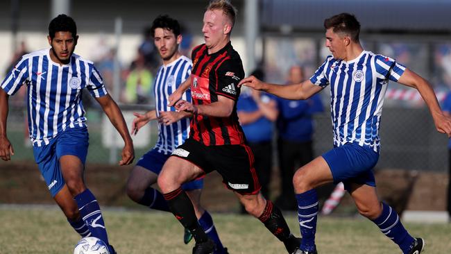 Three Yarraville players pursue Geelong’s Joshua Talev on Saturday. Picture: Mark Dadswell.