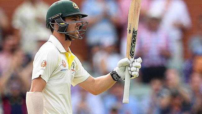 Australian batsman Travis Head raises his bat after scoring a half-century on day two at Adelaide. Picture: AAP