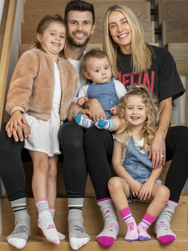 Richmond captain Trent Cotchin, wife Brooke and their three children Harper, 5, Mackenzie, 3 and Parker 10 months wearing the socks. Picture: Tim Carrafa