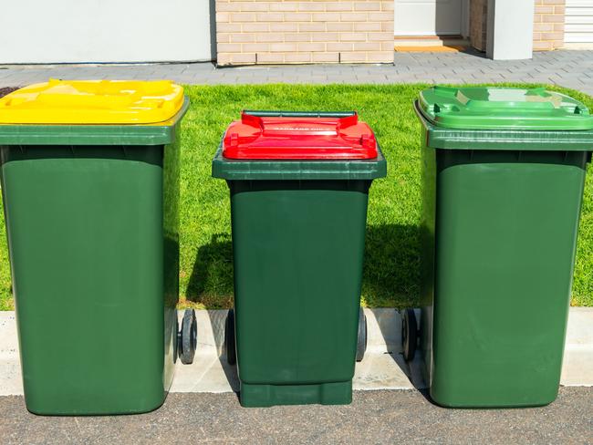 Australian wheelie bins with colourful lids for organic, general waste, and recycling products provided by local city council