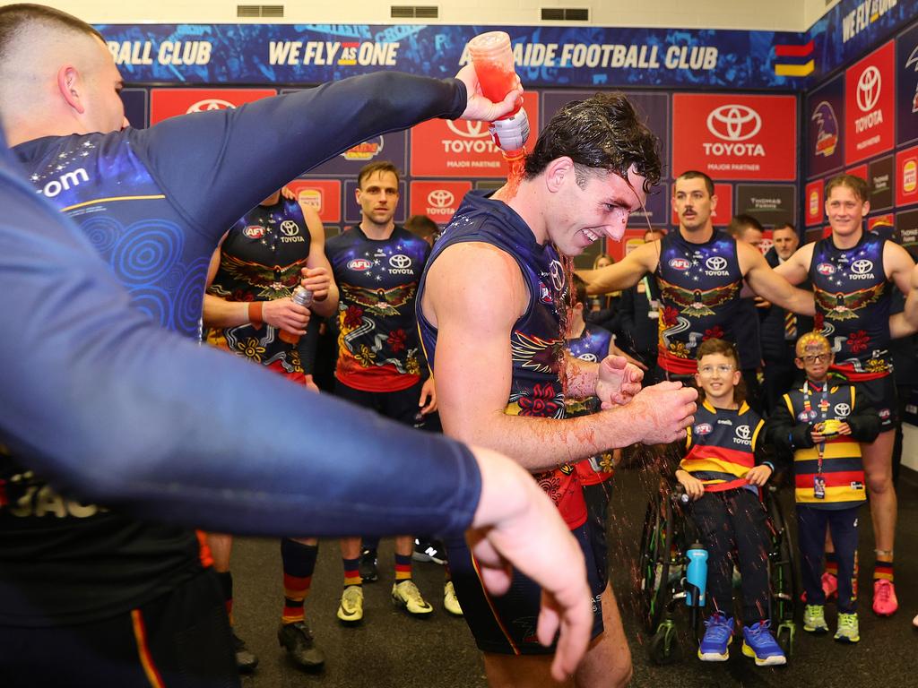 Hugh Bond is drenched after a win on his AFL debut. Picture: Sarah Reed/AFL Photos via Getty Images