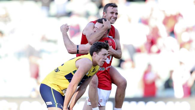 Jack Hayes slumps to the ground after last year’s controversial preliminary final as North Adelaide players celebrate. Picture: Sarah Reed