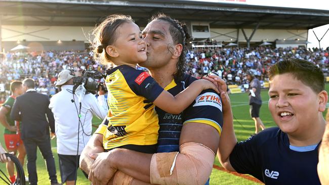 Leivaha Pulu of the Devils celebrates victory with his family.. (Photo by Bradley Kanaris/Getty Images)