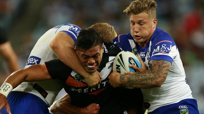 Tigers Tim Simona is tackled during the Wests Tigers v Bulldogs rugby league game at ANZ Stadium, Sydney. Pic Brett Costello