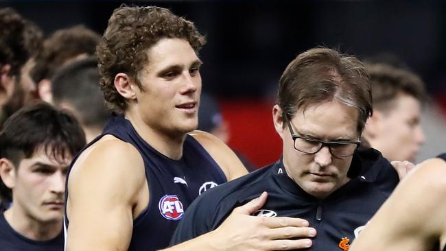 MELBOURNE, AUSTRALIA - AUGUST 21: David Teague, Senior Coach of the Blues is consoled by Charlie Curnow of the Blues at three quarter time during the 2021 AFL Round 23 match between the Carlton Blues and the GWS Giants at Marvel Stadium on August 21, 2021 in Melbourne, Australia. (Photo by Michael Willson/AFL Photos via Getty Images)