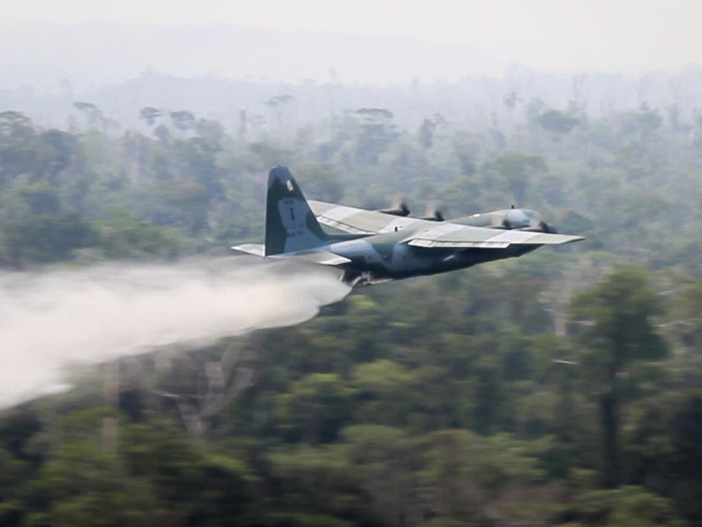 A C-130 Hercules aircraft dumps water to fight fires burning in the Amazon rainforest. Picture: Brazil Ministry of Defence