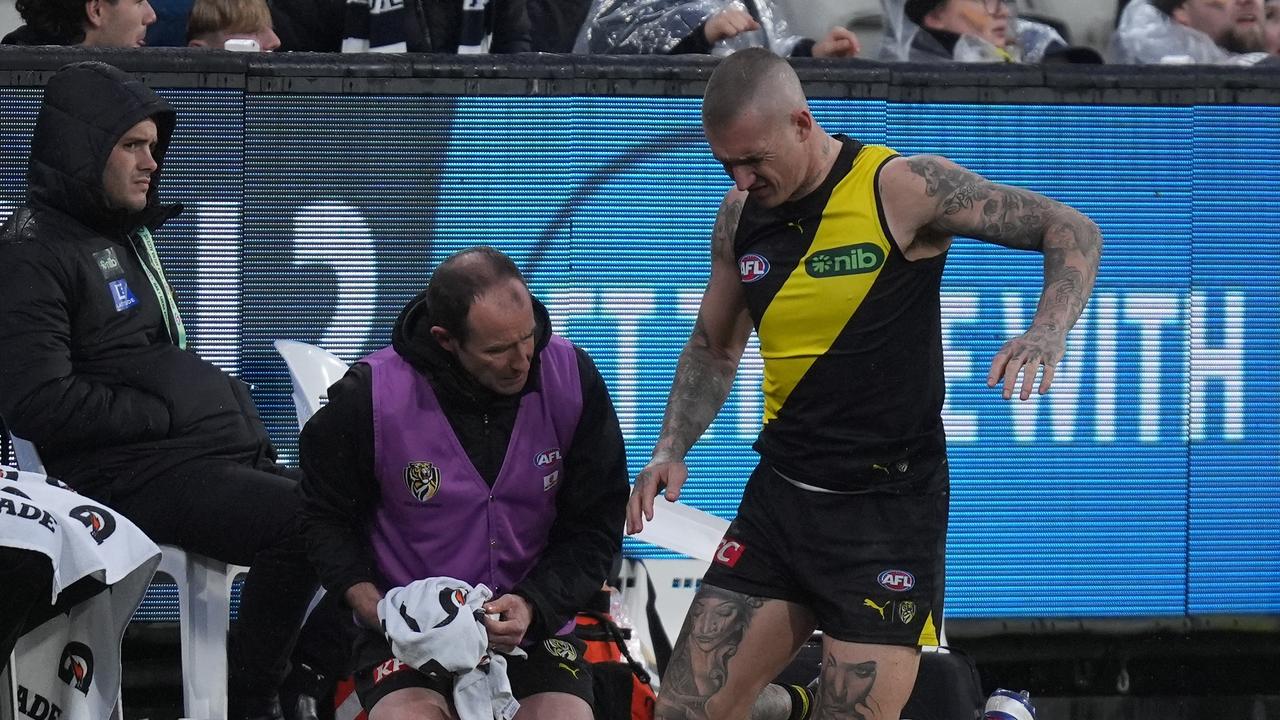 Dustin Martin receives medical attention on his back. (Photo by Daniel Pockett/Getty Images)