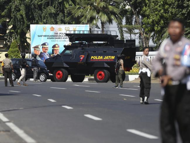 Officers block a road following an attack at the local police headquarters in Surabaya. Picture: AP Photo/Achmad Ibrahim