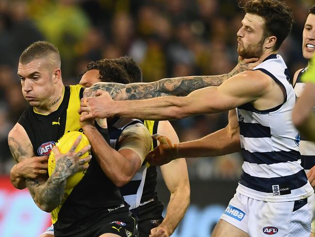 Dusty fends off a tackle by Jordan Murdoch during the AFL Second Qualifying Final Match, 2017. Photo by Quinn Rooney/Getty Images