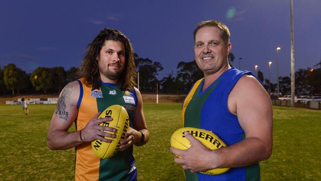 Golden Grove stalwart Rohan Shenton (left) in a heritage guernsey with 1997 inaugural player Kym Dobie. Shenton played his 250th game for the club on Saturday. Picture: Brenton Edwards