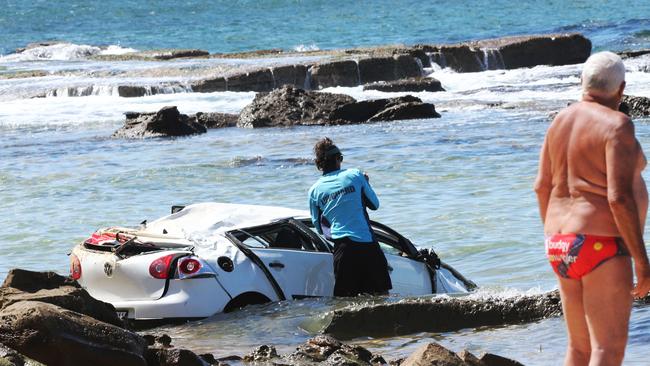 The scene at Bar Beach, Newcastle, where a car plunged of a car park lookout into the sea. Picture by Peter Lorimer.