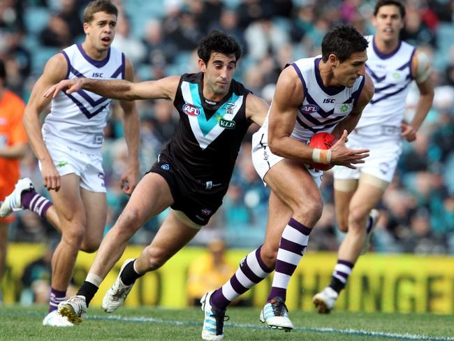 Port’s Dom Cassisi chases Fremantle’s Matthew Pavlich during the 2012 match. Picture: Sarah Reed