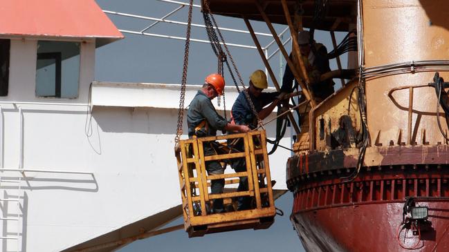 Workmen on a ship in Tropical Reef Shipyard