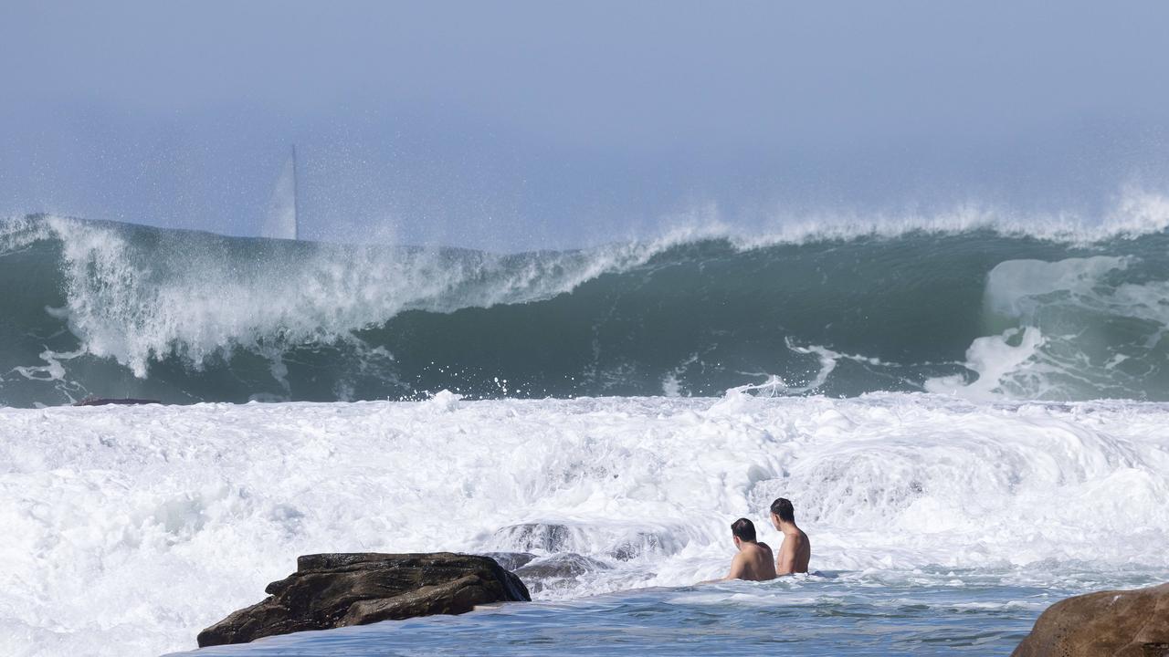 People continue to swim despite dangerous surf conditions at Whale Beach, NSW.