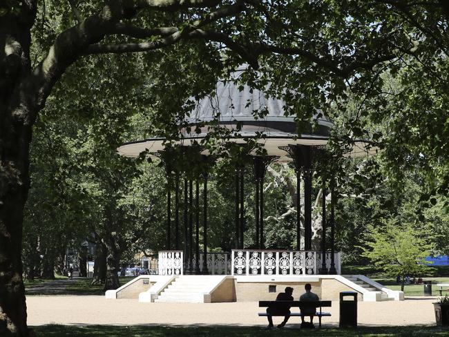 People sit on benches near the bandstand in Southwark Park in London. Picture: AP