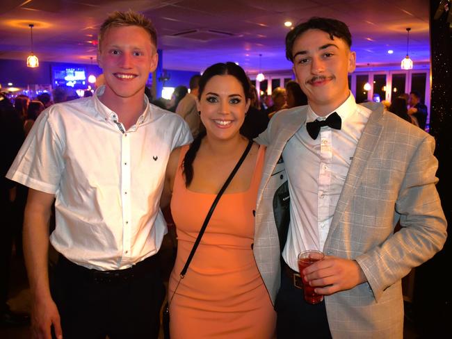 Rhys Luxford, Sarah Hegarty and Jake Brown having a great night at the Cowwarr Saints Football &amp; Netball Club Golden Gala Ball 2024. Picture: Jack Colantuono