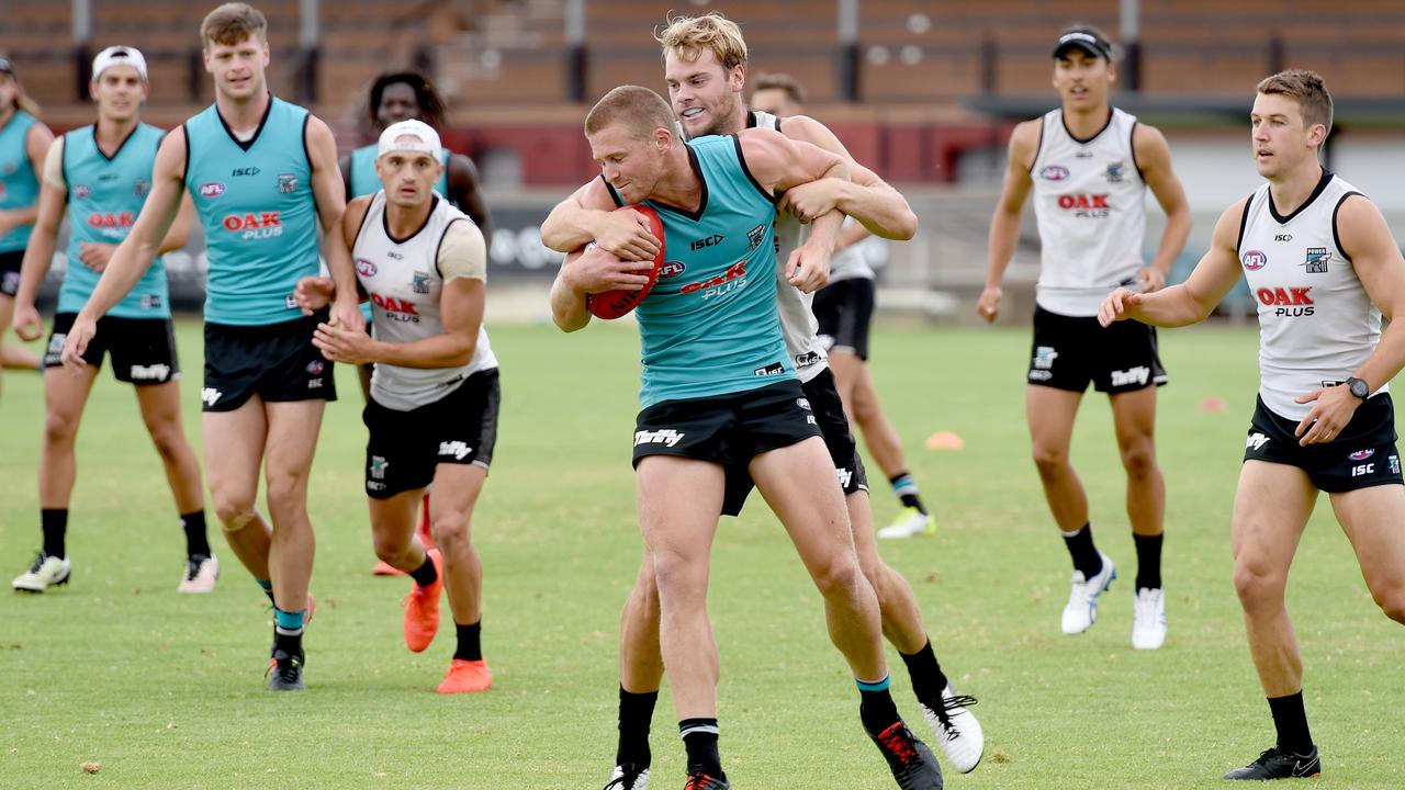 Port Adelaide’s Jack Watts tackles Tom Clurey during training at Alberton on Wednesday. Picture: Naomi Jellicoe