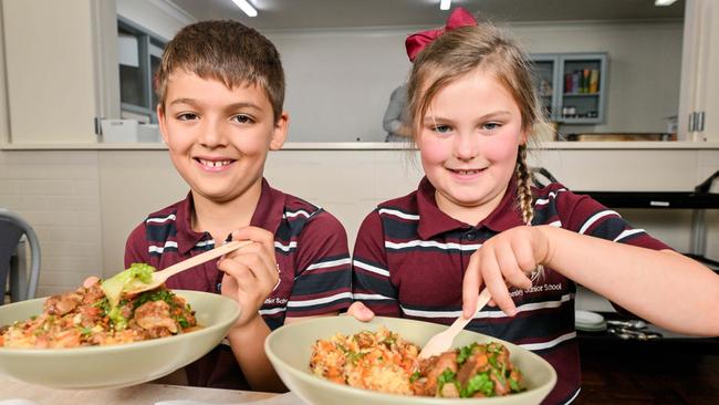 Eight year olds Mico and Charlotte from Annesley Junior School in Adelaide enjoy a cafferteria style lunch as part of the Budding Lunch program. Picture: Brenton Edwards