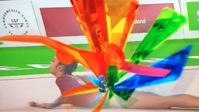 The Commonwealth Games logo emerges in full rainbow bloom.