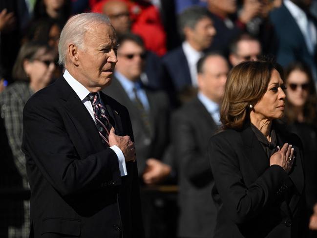 US President Joe Biden (L) and Vice President Kamala Harris stand at attention during a wreath-laying ceremony at The Tomb of the Unknown Soldier at Arlington National Cemetery to mark Veterans' Day on November 11, 2024 in Arlington, Virginia. (Photo by ANDREW CABALLERO-REYNOLDS / AFP)