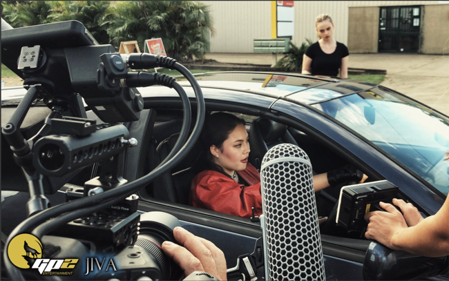 Axielle Doddridge (seated, in the car) on a shoot. She has her heart set on an acting career.