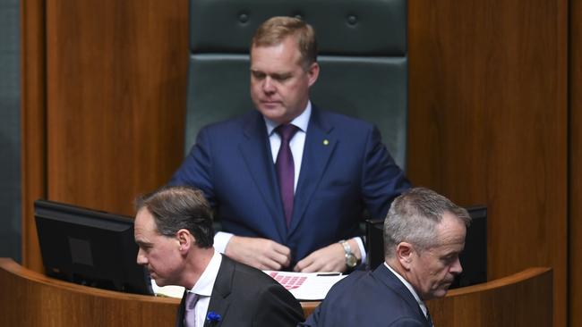 Greg Hunt, left, and Bill Shorten cross paths during the division. Picture: AAP/Lukas Coch