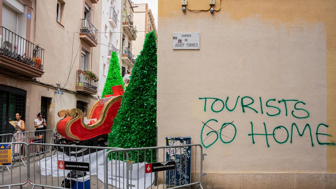 An anti-tourism graffiti appears near one of the streets that residents decorate during the city's most popular Fiesta Mayor de Gracia, in Barcelona, Spain, on August 16, 2023. Picture: Marc Asensio/NurPhoto