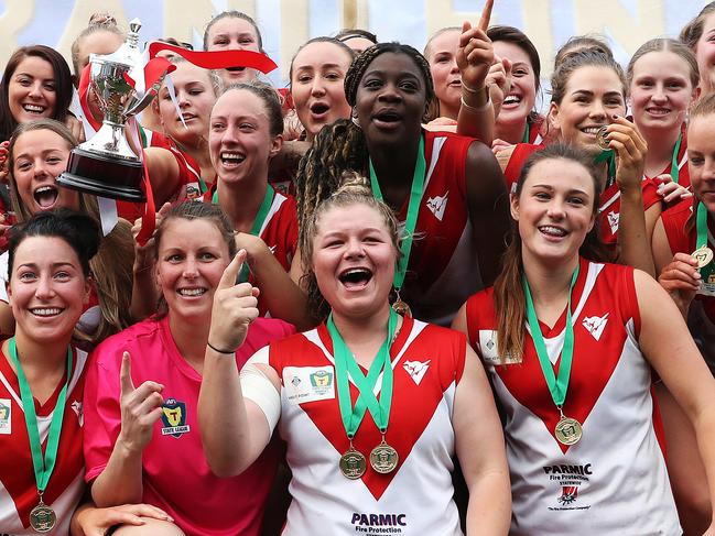 Clarence player Maddy Smith front centre celebrates her team’s grand final win over Launceston. Picture: NIKKI DAVIS-JONES